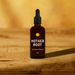 Bottle of 'Mother Root' Sundown Bitters on a wooden surface with a warm background